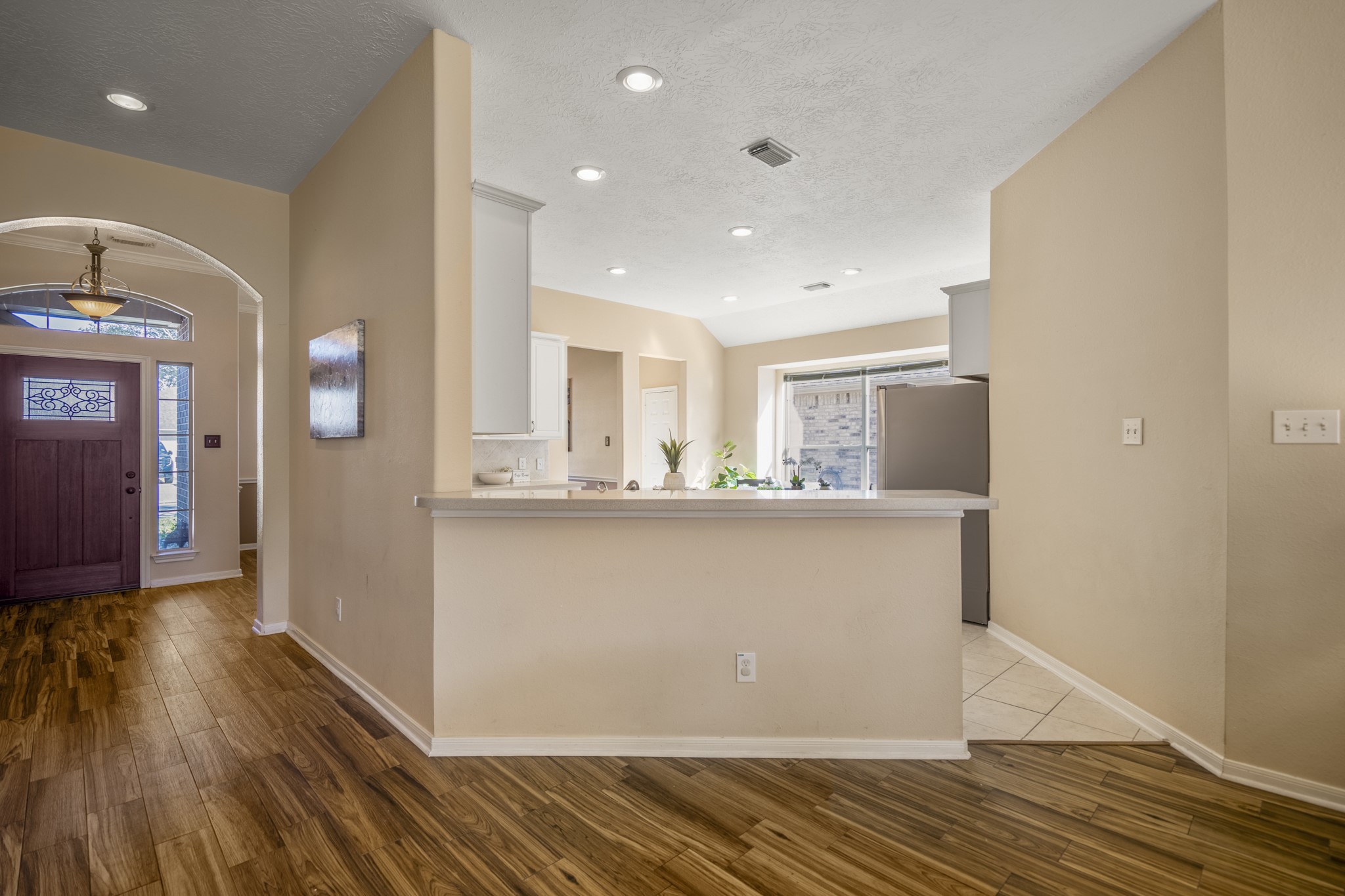 21107 Coldde Meadow Lane Spring, TX 77379 - Photo 10 of 50 Just beyond the living room, the kitchen opens into the main living areas with a raised bar that keeps conversation close while meals come together. Abundant cabinetry and generous counter space make daily routines easy, while updated appliances add modern convenience to the space.