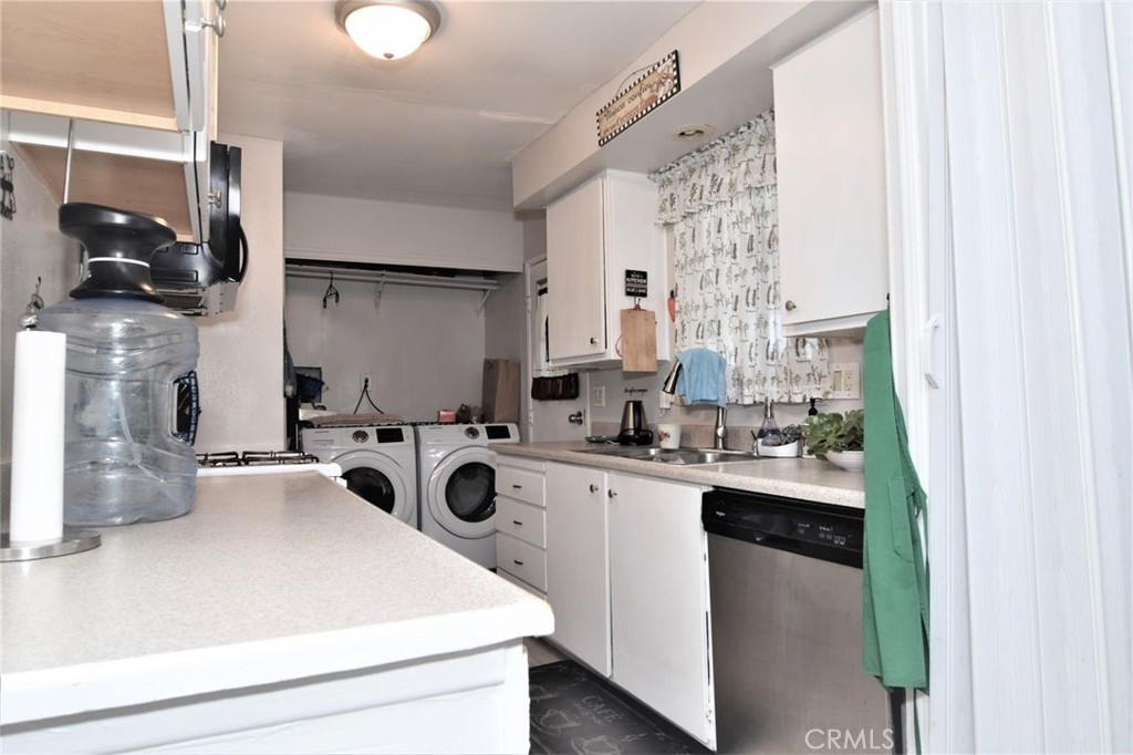 3255 East Avenue R, Unit 98 Littlerock, CA 92550 - Photo 7 of 12 a kitchen with a sink a stove and cabinets