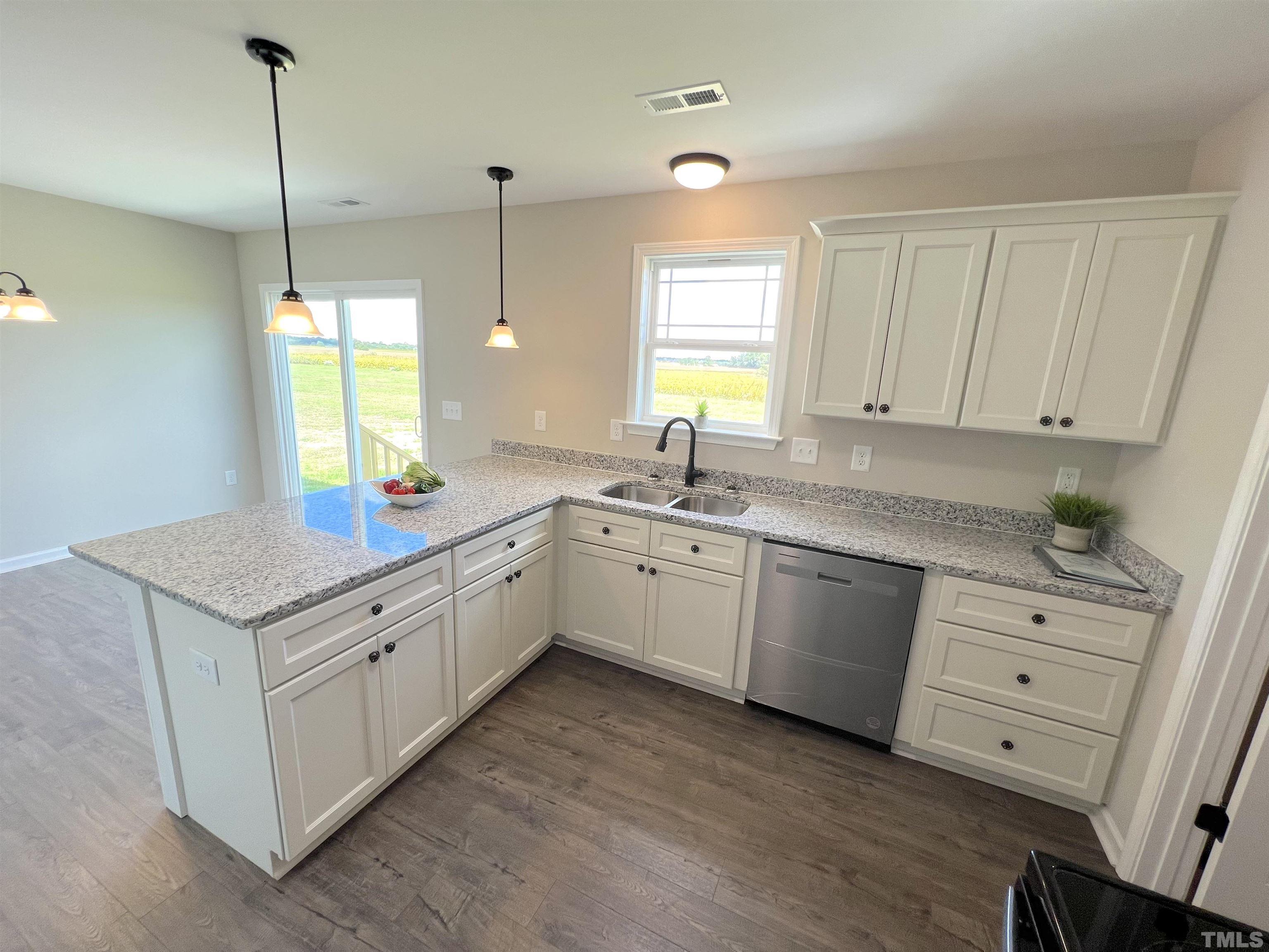 111 Adds Road Pikeville, NC 27863 - Photo 11 of 23 a kitchen that has a sink a window in it and wooden cabinets