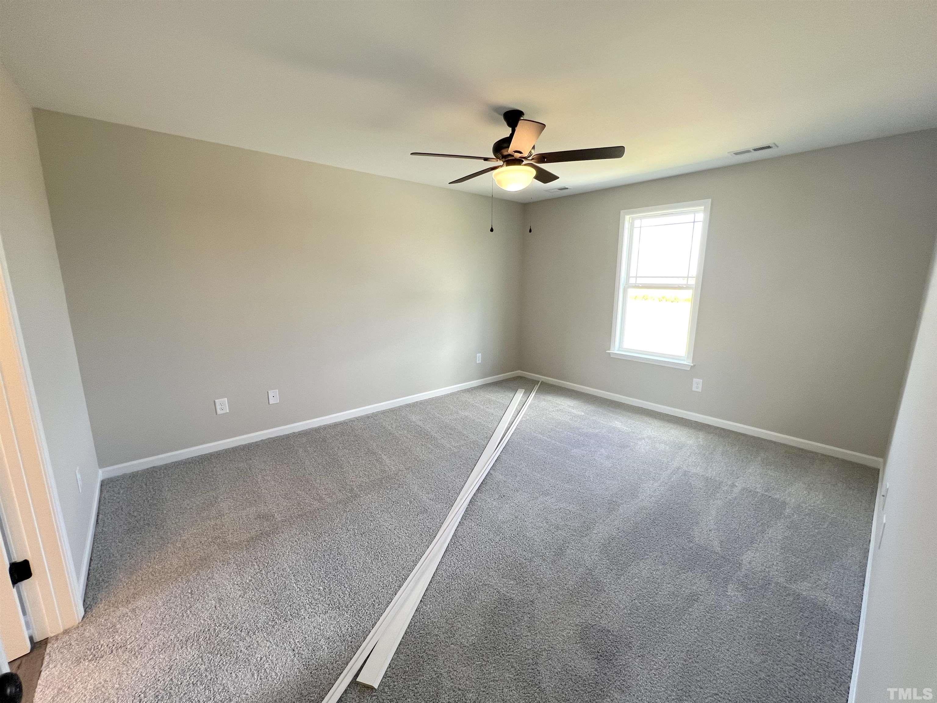 111 Adds Road Pikeville, NC 27863 - Photo 13 of 23 an empty room with windows and fan