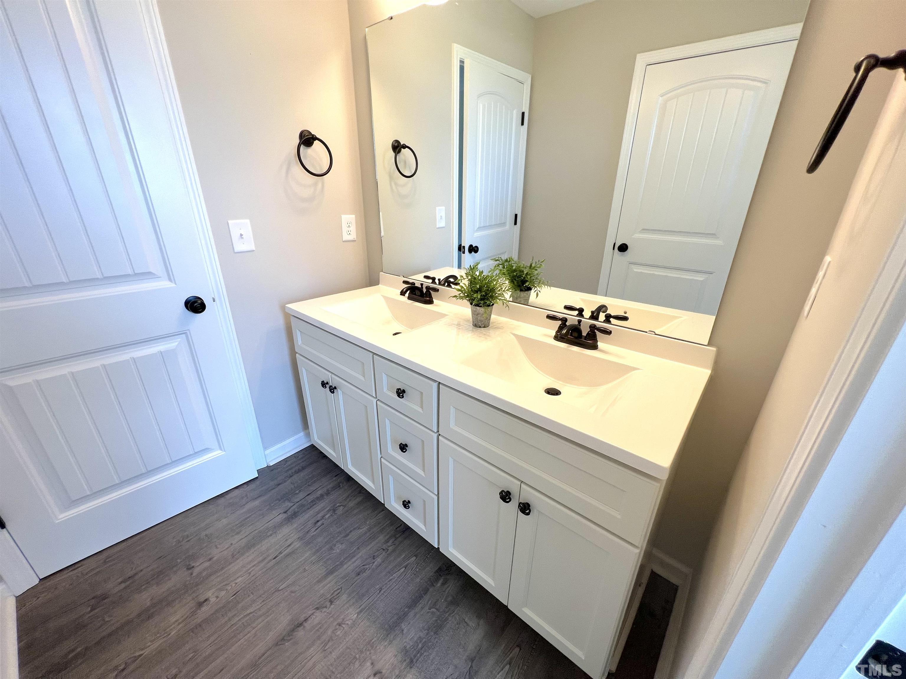 111 Adds Road Pikeville, NC 27863 - Photo 18 of 23 a bathroom with a double vanity sink and mirror