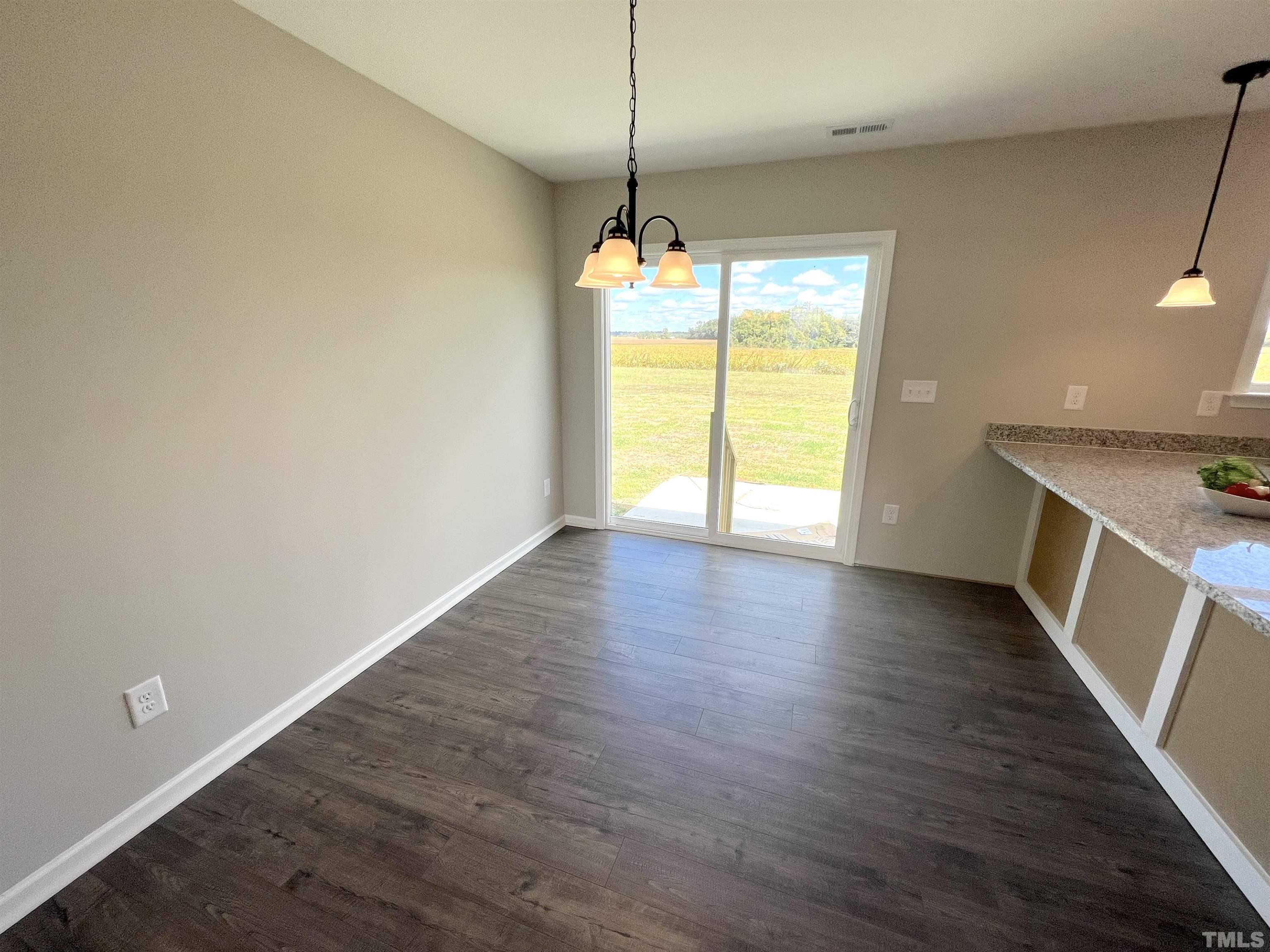 111 Adds Road Pikeville, NC 27863 - Photo 6 of 23 a view of an empty room with a window and wooden floor