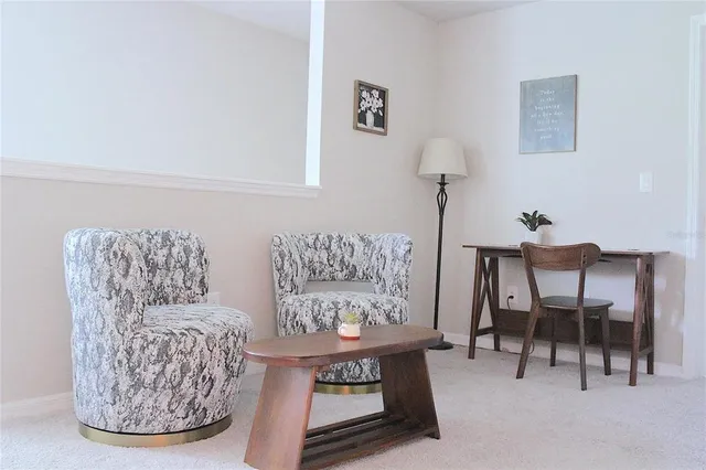 a living room with furniture a couch and a potted plant