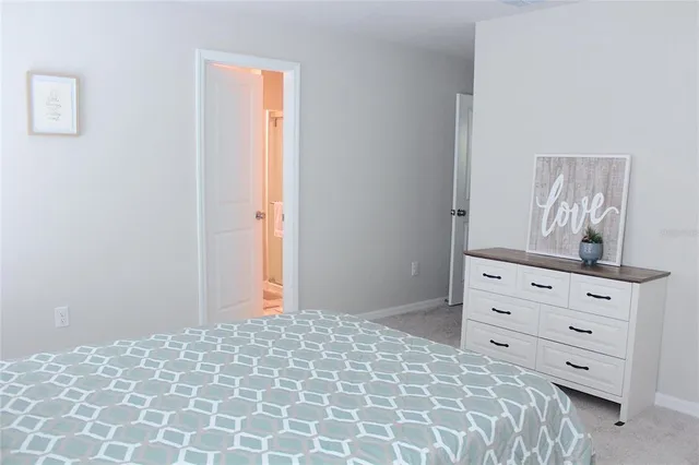 a bedroom with a bed and a dresser