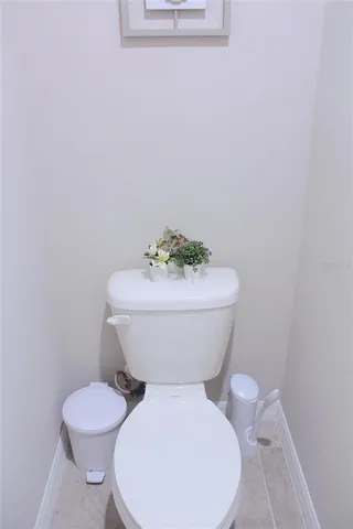 a white toilet sitting next to a white sink