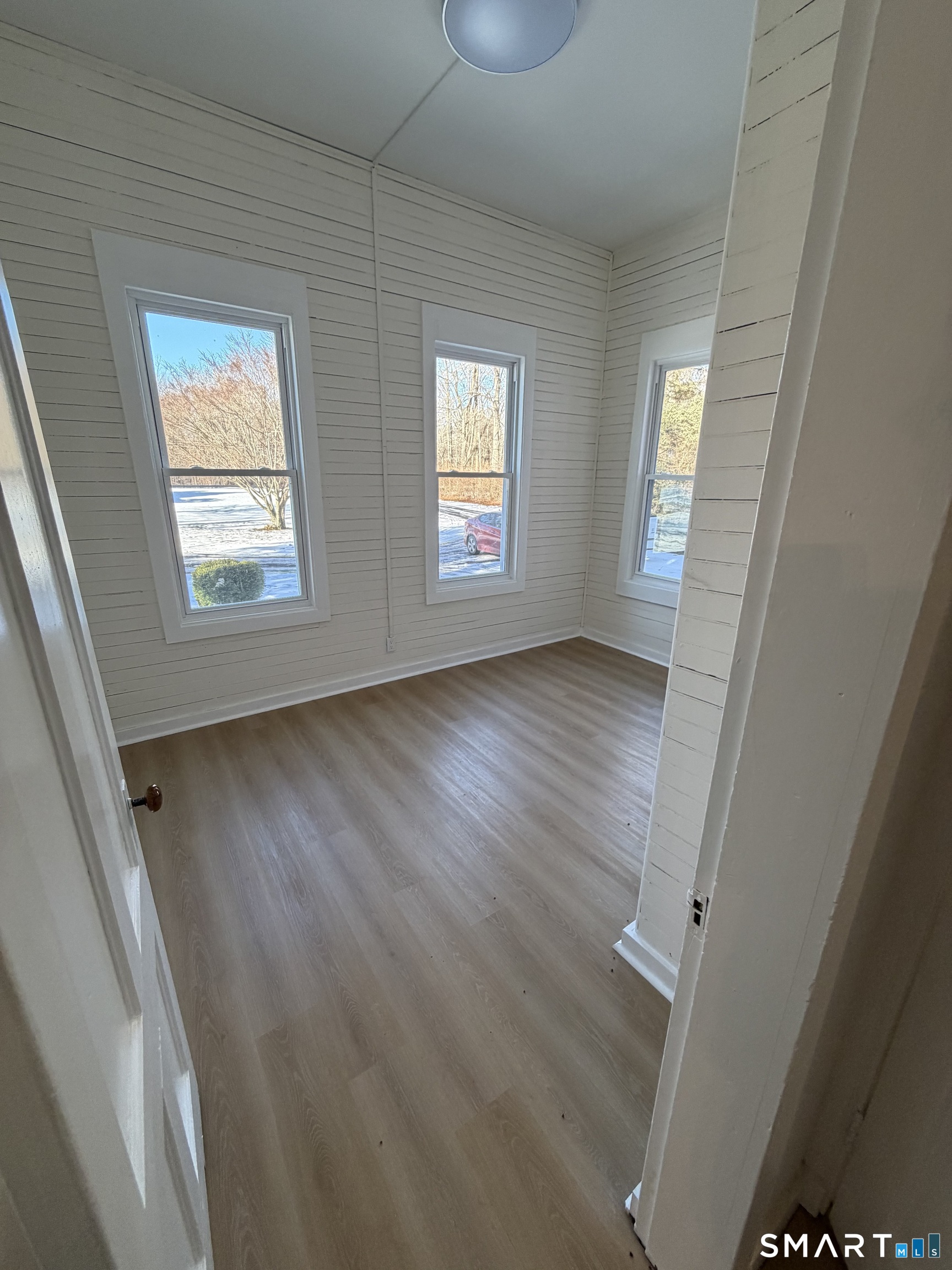 473 Amity Road Woodbridge, CT 06525 - Photo 16 of 16 a view of an empty room with wooden floor and a window