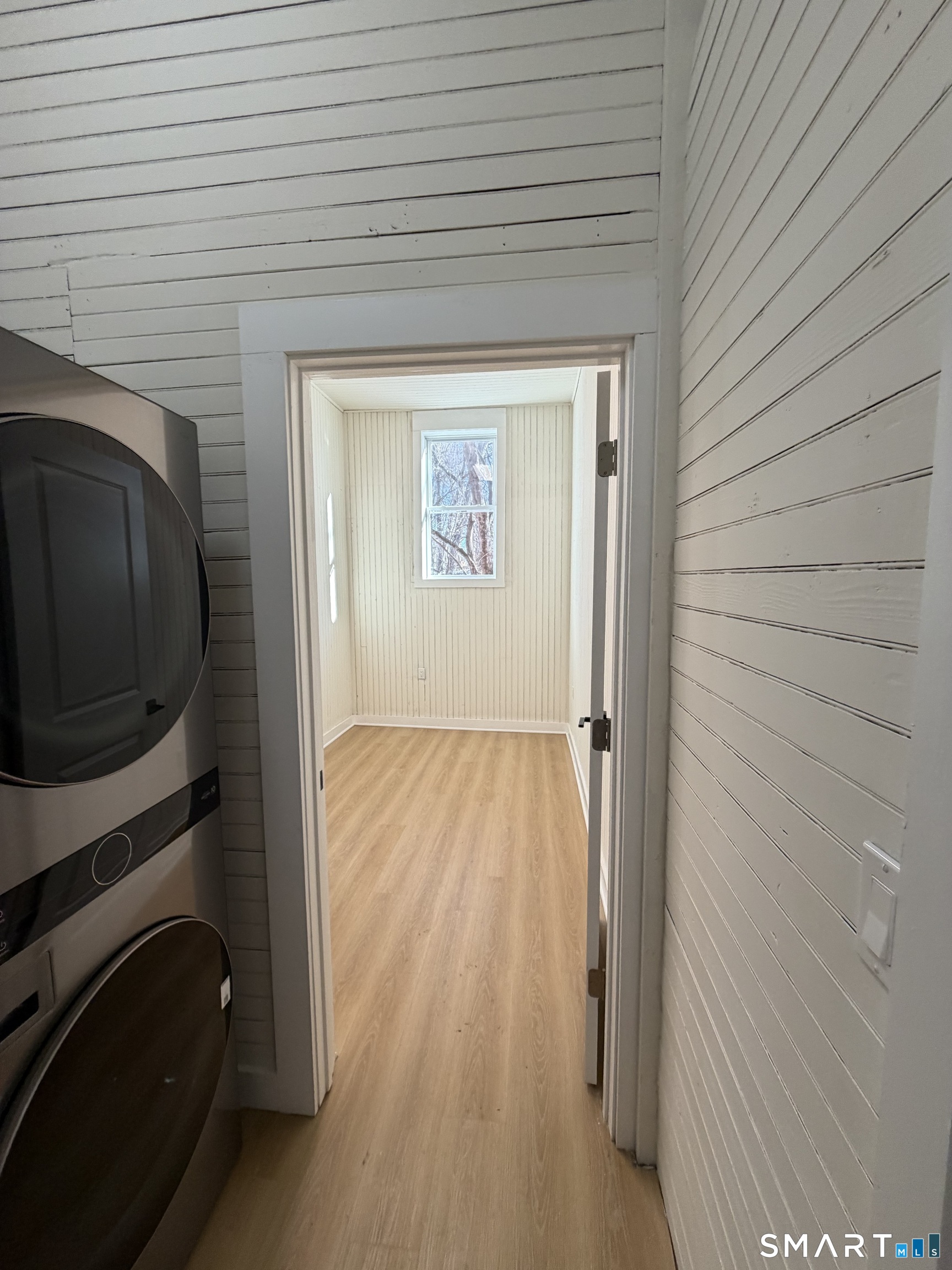 473 Amity Road Woodbridge, CT 06525 - Photo 3 of 16 a view of a hallway with wooden floor and staircase
