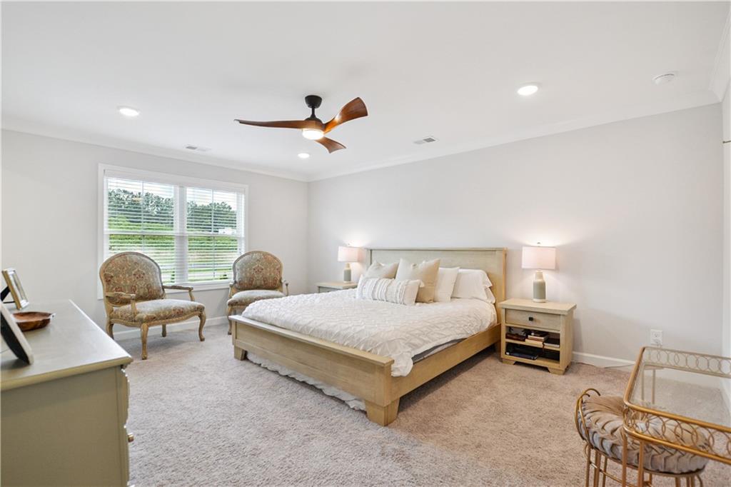 765 Trevett Way Marietta, GA 30066 - Photo 17 of 44 a spacious bedroom with a bed and a chandelier