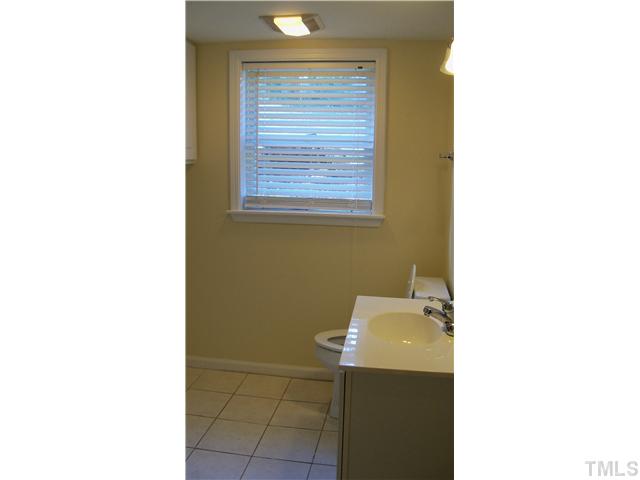 2124 Balboa Road Raleigh, NC 27603 - Photo 9 of 24 Lower level full bath with ceramic flooring and washer/dryer area