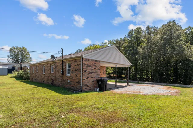 a view of a house with backyard and porch