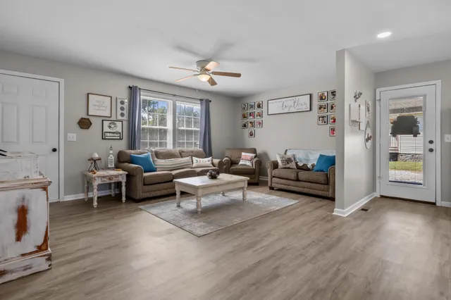 a living room with furniture and wooden floor