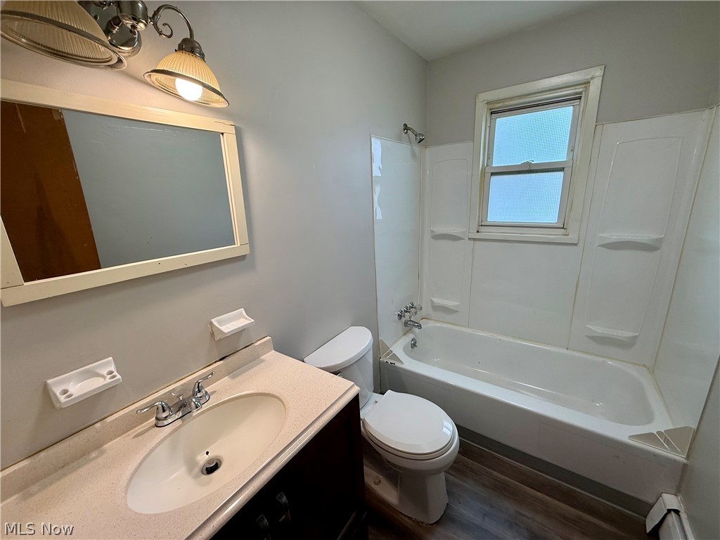 4652 Warner Road, Unit 3 Cleveland, OH 44125 - Photo 10 of 13 Bathroom featuring shower combination, vanity, and dark wood finished floors