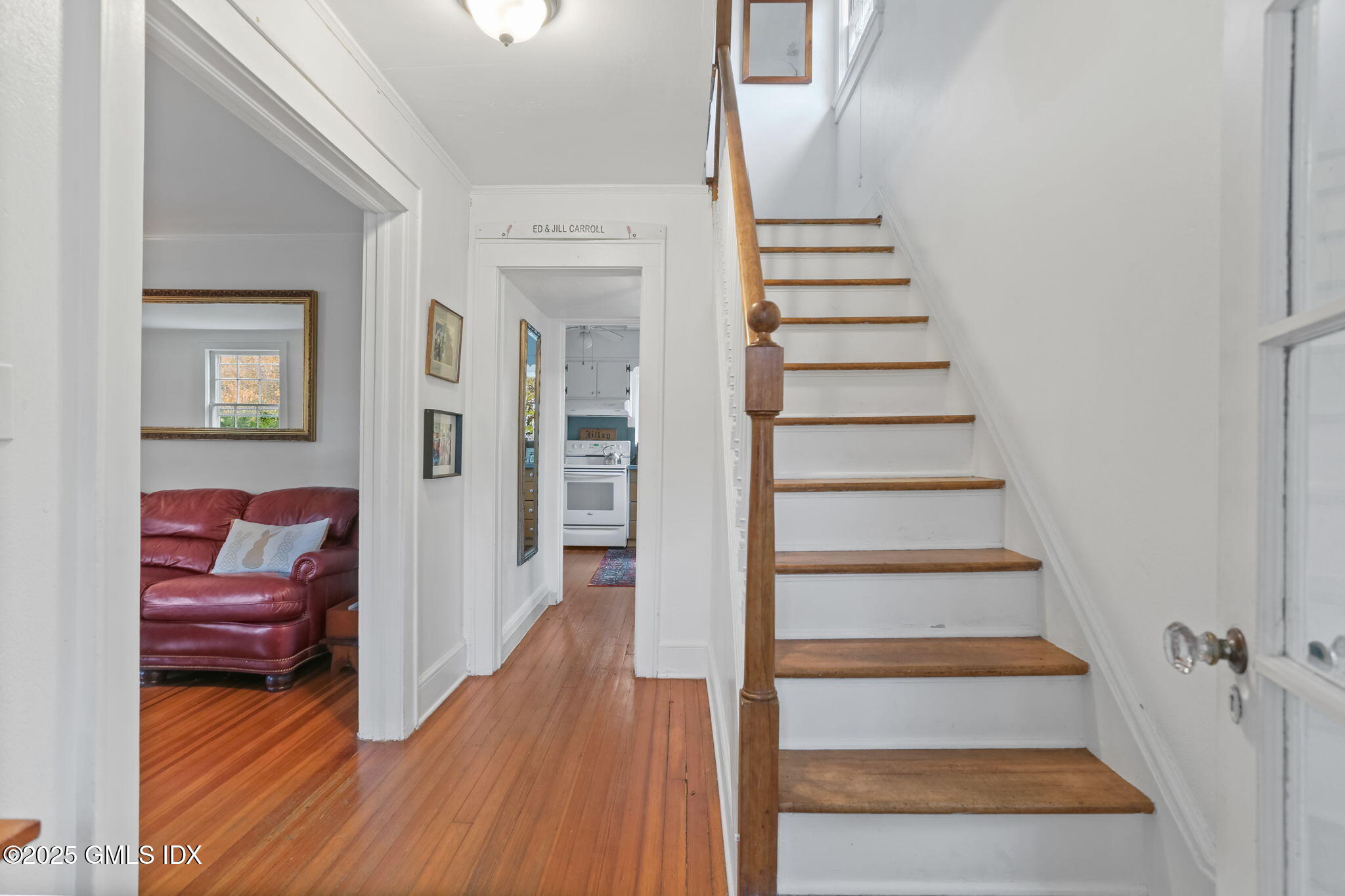 7 Highview Avenue Old Greenwich, CT 06870 - Photo 4 of 28 a view of a hallway to a livingroom with wooden floor and stairs