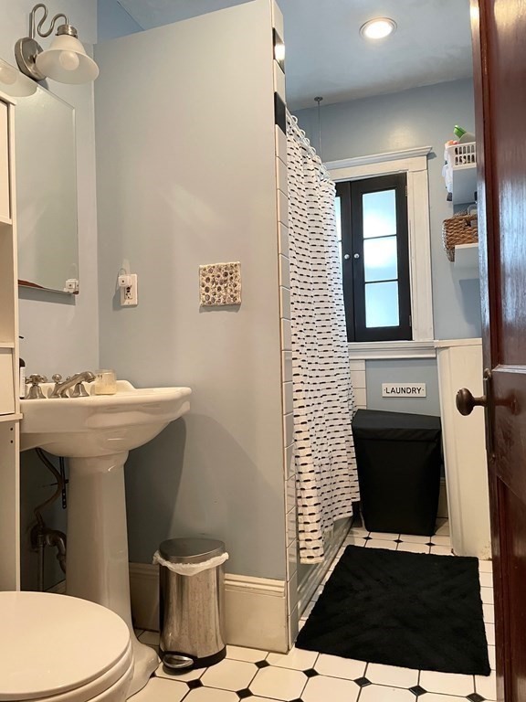 51 Presentation Road, Unit 1 Boston, MA 02135 - Photo 12 of 15 a bathroom with a sink and a toilet