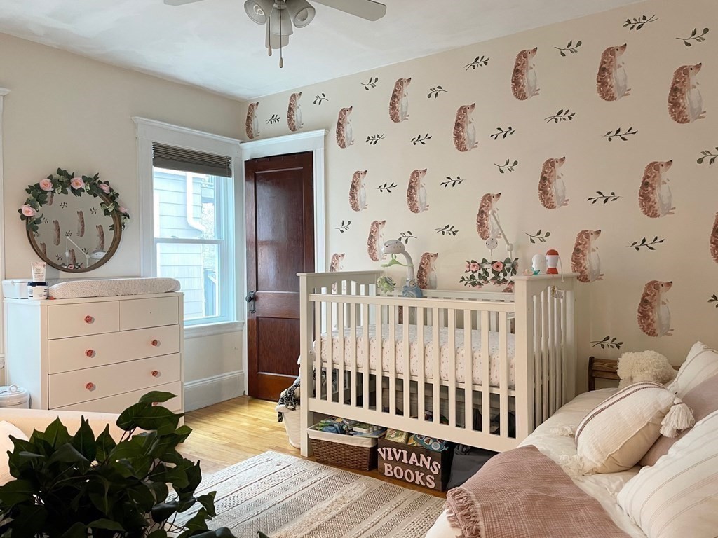 51 Presentation Road, Unit 1 Boston, MA 02135 - Photo 8 of 15 a bedroom with a bed and a window