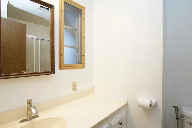 a view of a bathroom with a sink and mirror