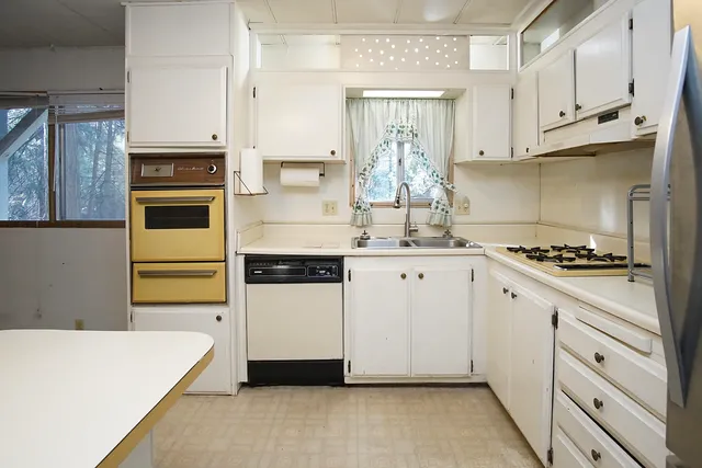 a kitchen with stainless steel appliances granite countertop a stove and a refrigerator