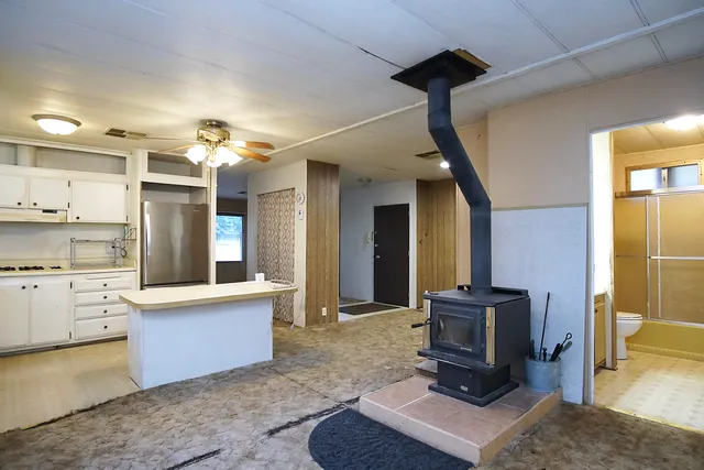 a living room with kitchen island furniture and a fireplace