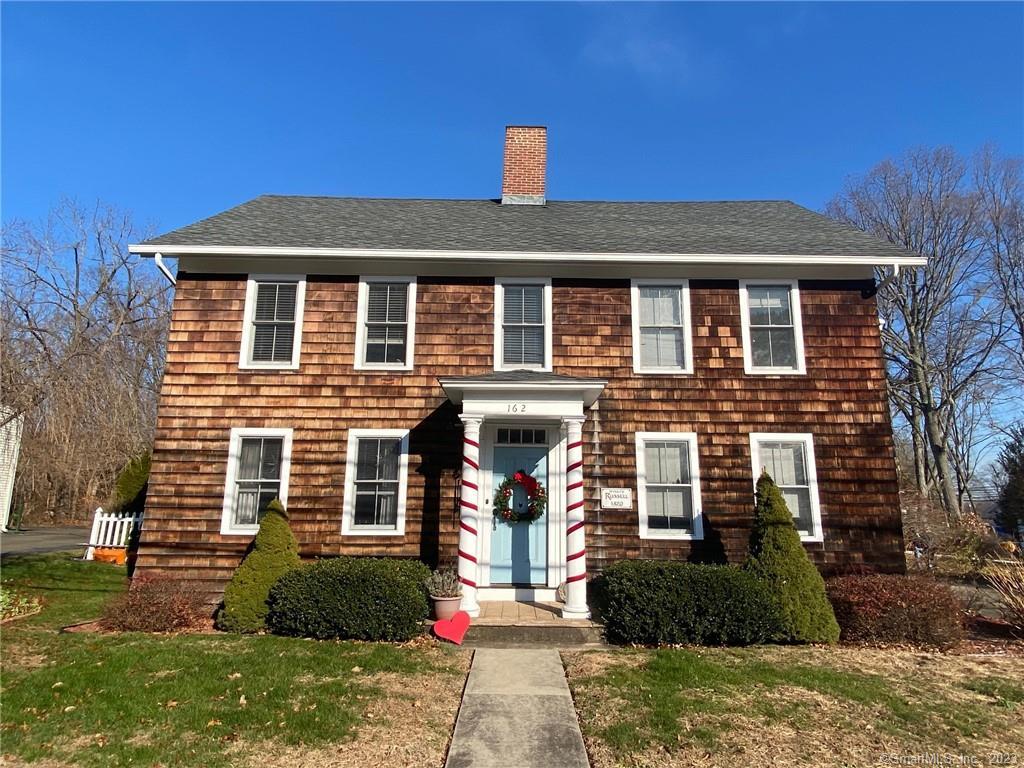 162 Main Street, Unit 1 Branford, CT 06405 - Photo 1 of 1 a front view of a house with a yard