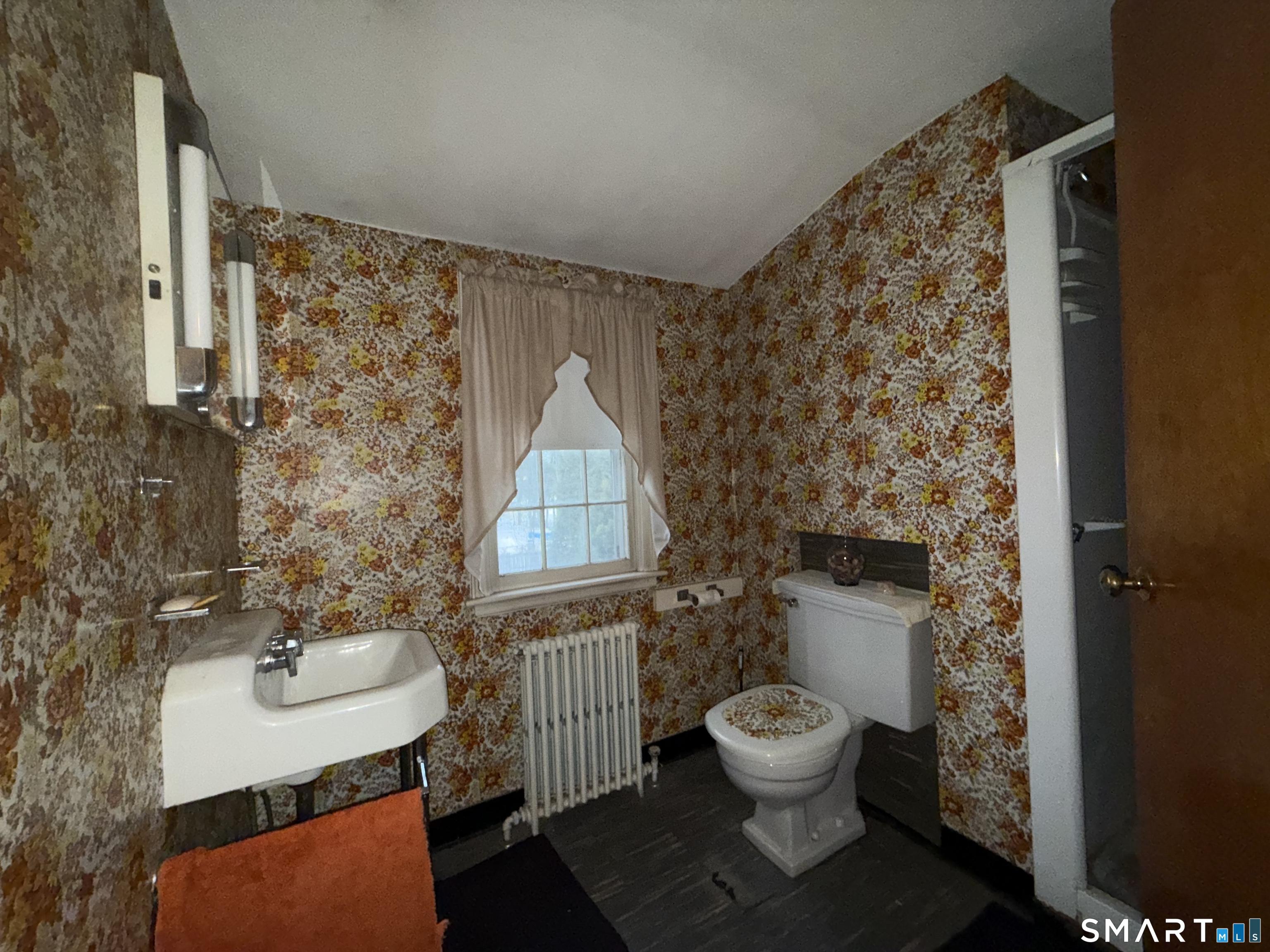 233 Church Street Newington, CT 06111 - Photo 12 of 18 a bathroom with a toilet a sink and a mirror