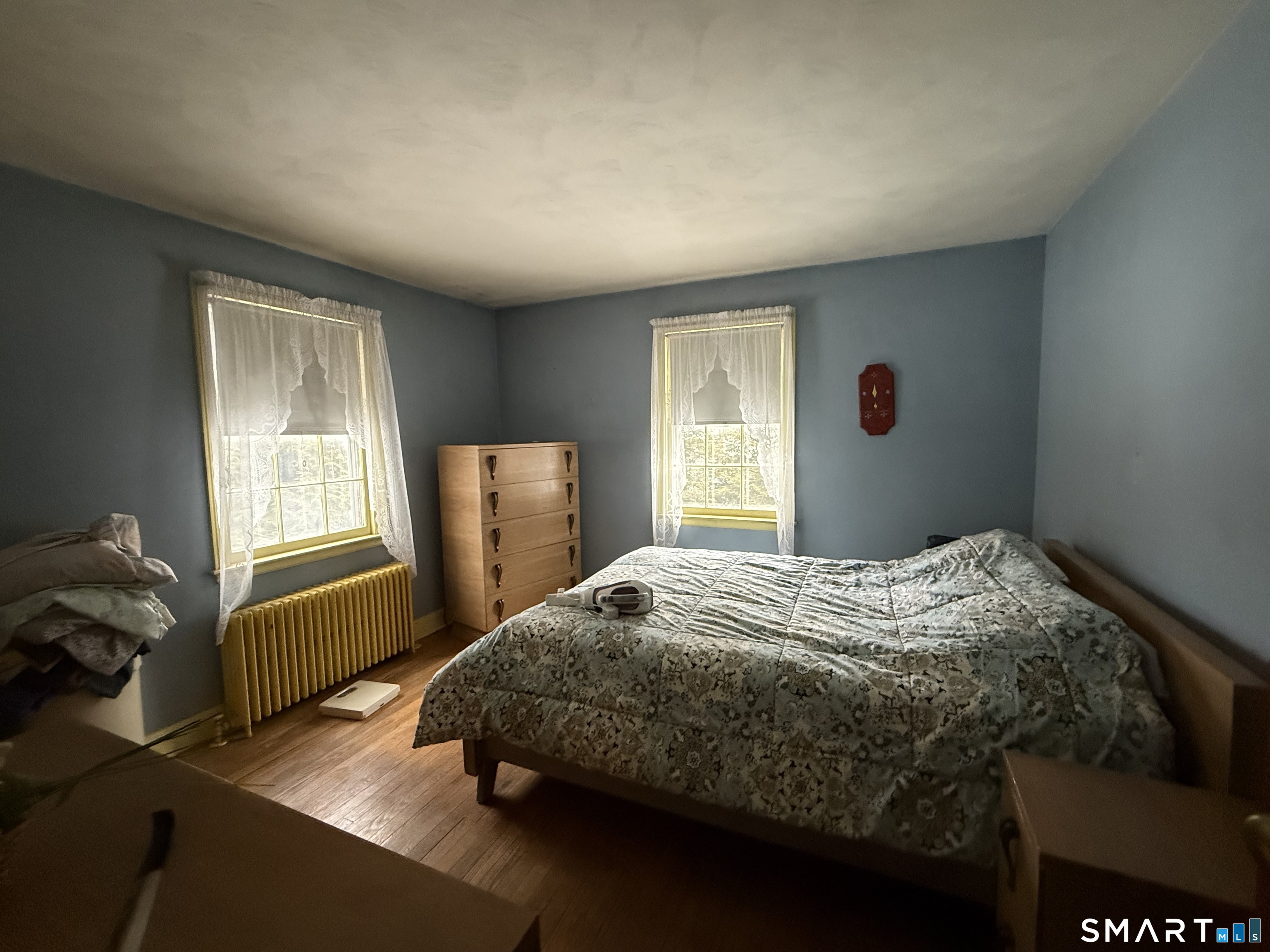 233 Church Street Newington, CT 06111 - Photo 5 of 18 a bedroom with a bed and wooden floor