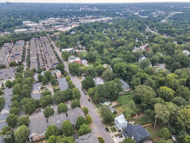 an aerial view of residential houses with outdoor space and street view