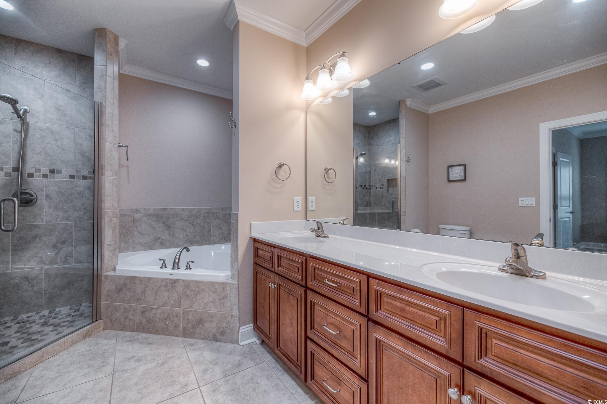 103 Charles Towne Lane Murrells Inlet, SC 29576 - Photo 15 of 23 Full bathroom featuring tile patterned flooring, a bath, double vanity, ornamental molding, and a shower stall