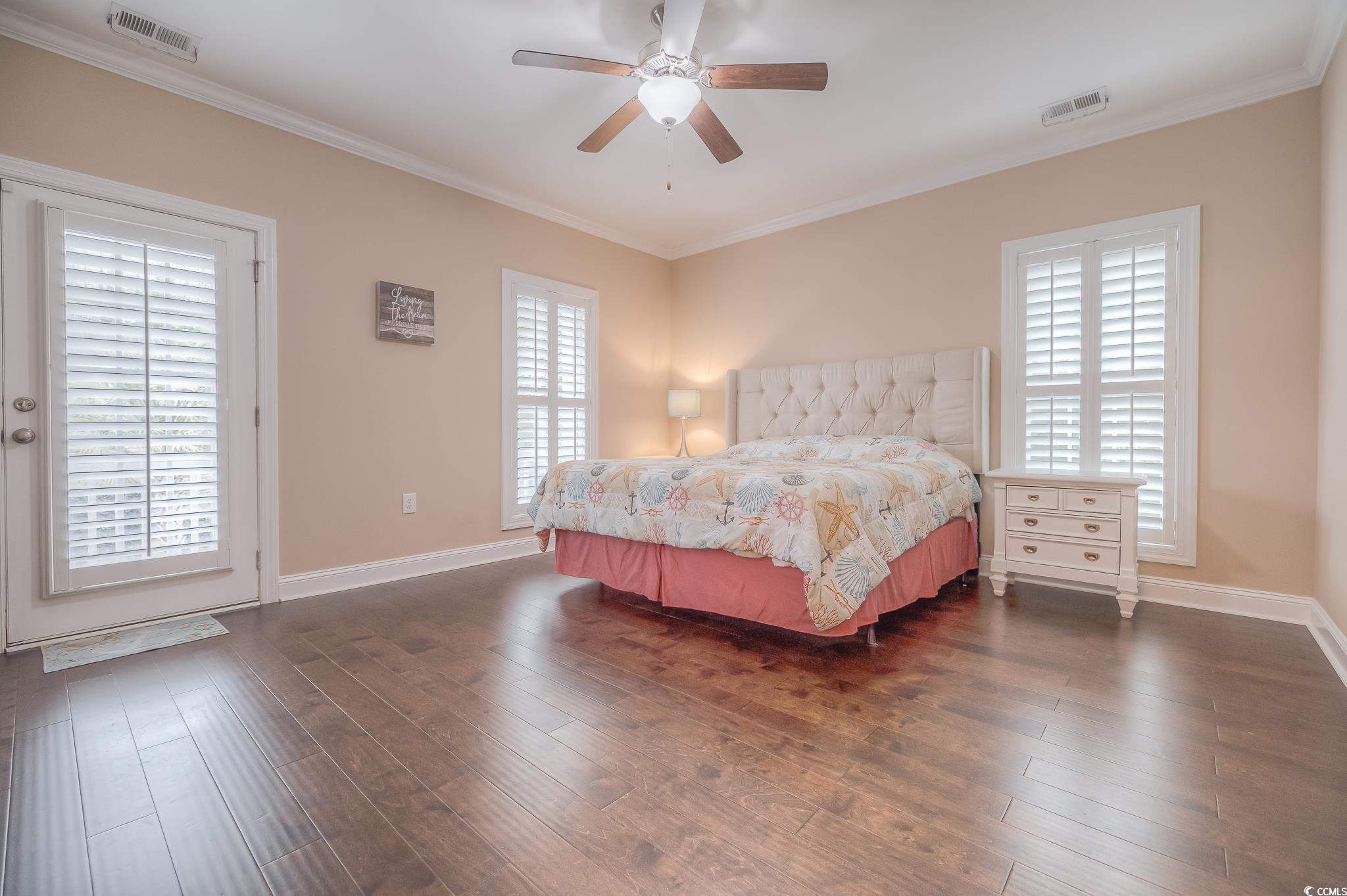 103 Charles Towne Lane Murrells Inlet, SC 29576 - Photo 17 of 23 Bedroom featuring crown molding, dark wood-type flooring, and a ceiling fan
