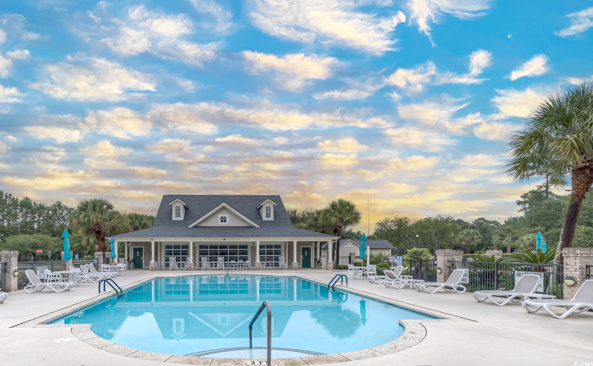 103 Charles Towne Lane Murrells Inlet, SC 29576 - Photo 23 of 23 Community pool featuring a patio area and view of scattered trees