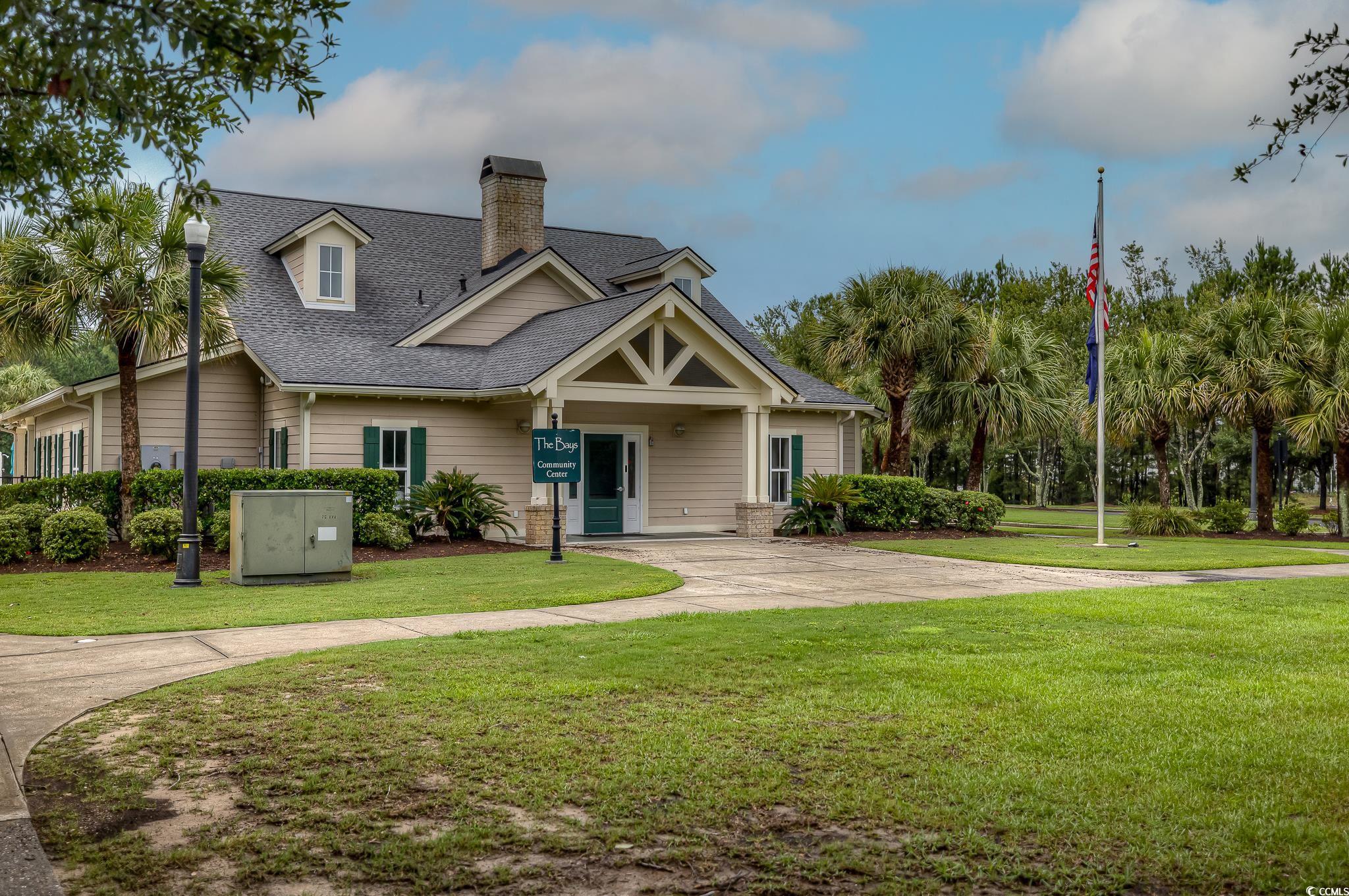 103 Charles Towne Lane Murrells Inlet, SC 29576 - Photo 3 of 23 View of front of property with roof with shingles, a chimney, and a front lawn