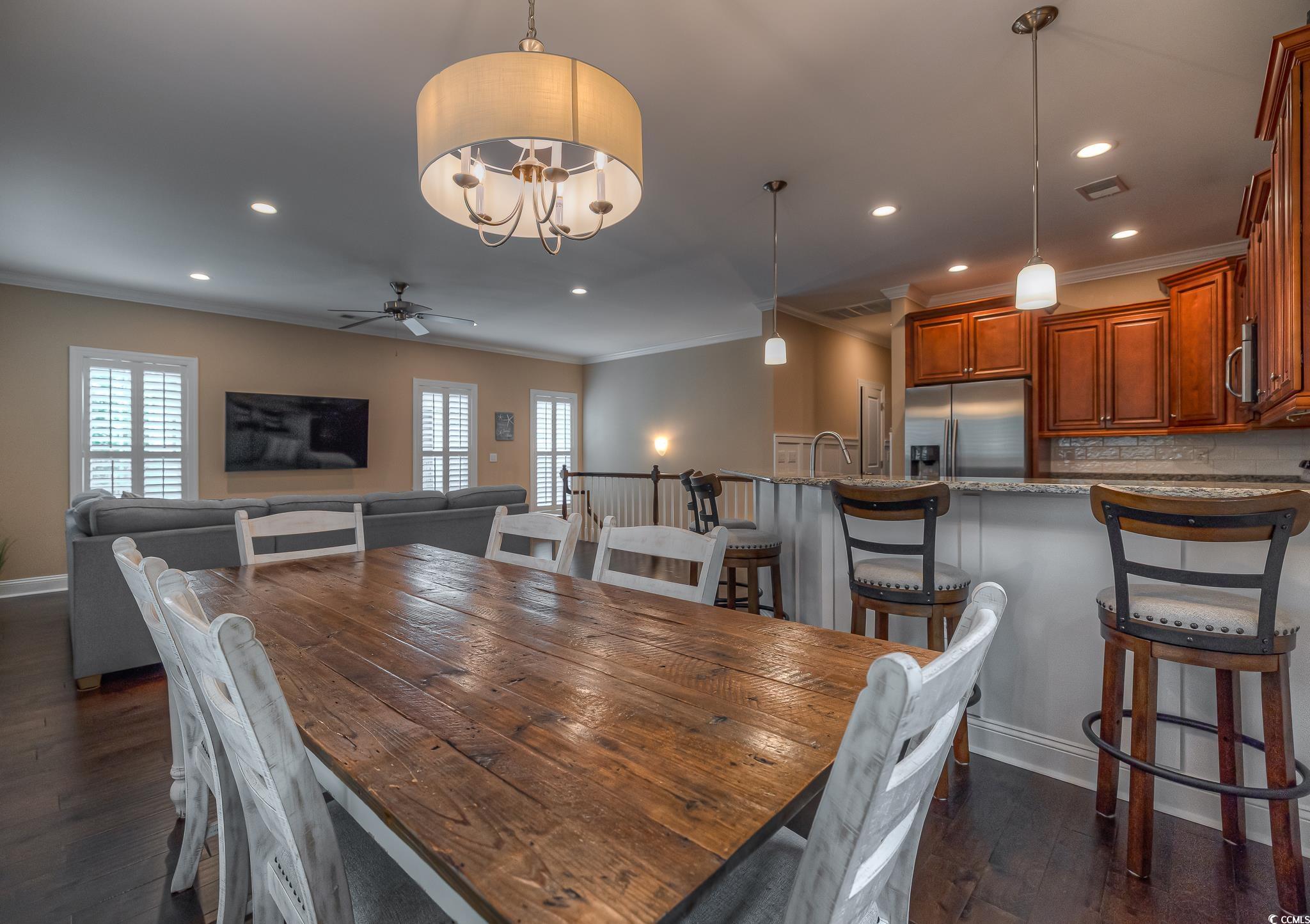 103 Charles Towne Lane Murrells Inlet, SC 29576 - Photo 7 of 23 Dining space with crown molding, dark wood-type flooring, recessed lighting, ceiling fan, and a chandelier