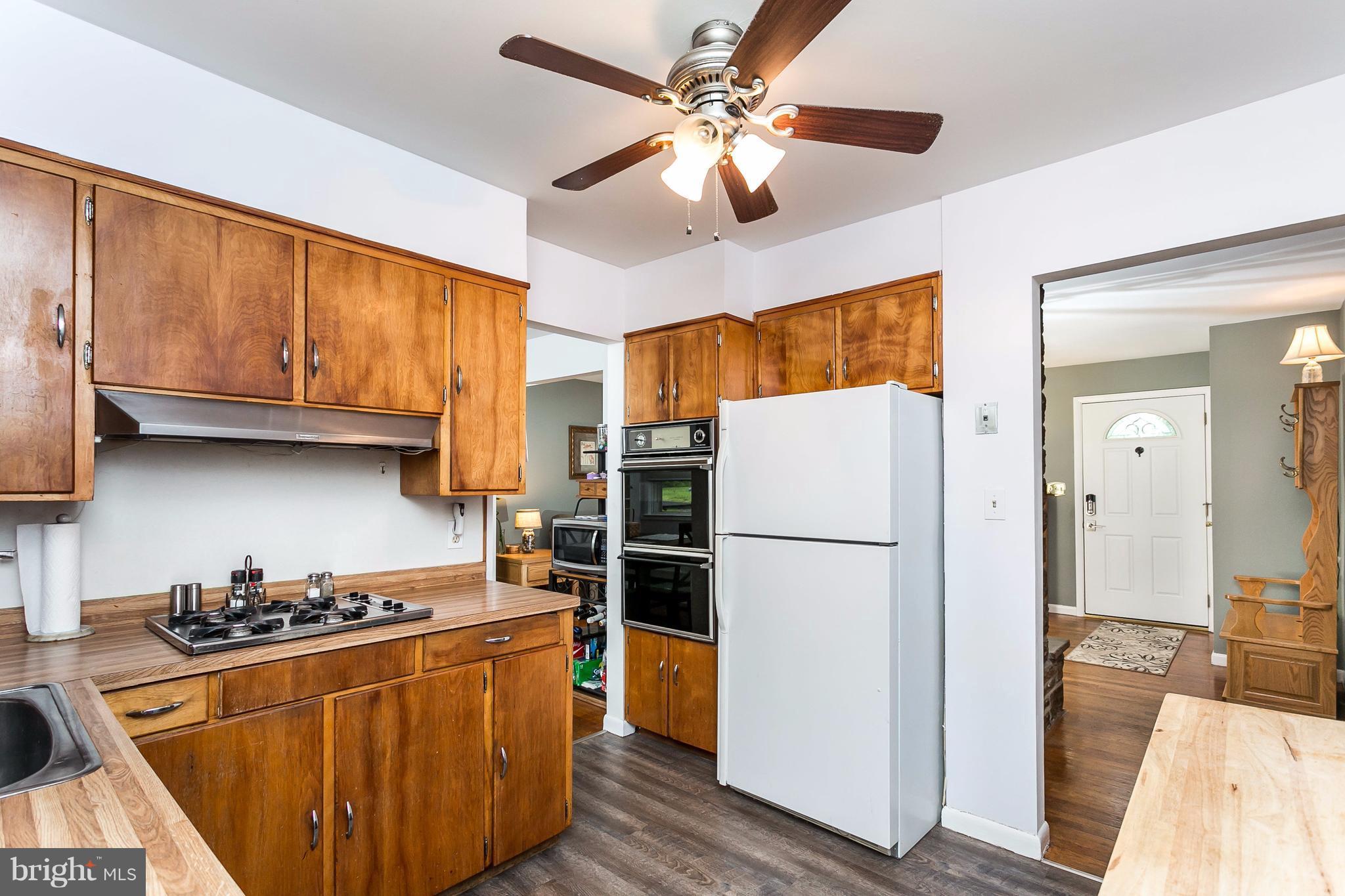 9216 Avondale Road Baltimore, MD 21234 - Photo 11 of 30 Kitchen with cooktop, wall over and refrigerator