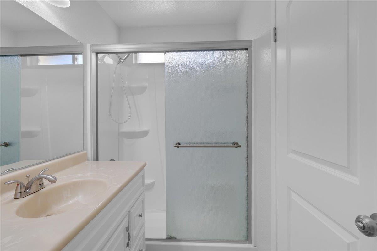 159 Dolphin Circle Marina, CA 93933 - Photo 25 of 31 a bathroom with a granite countertop sink and shower