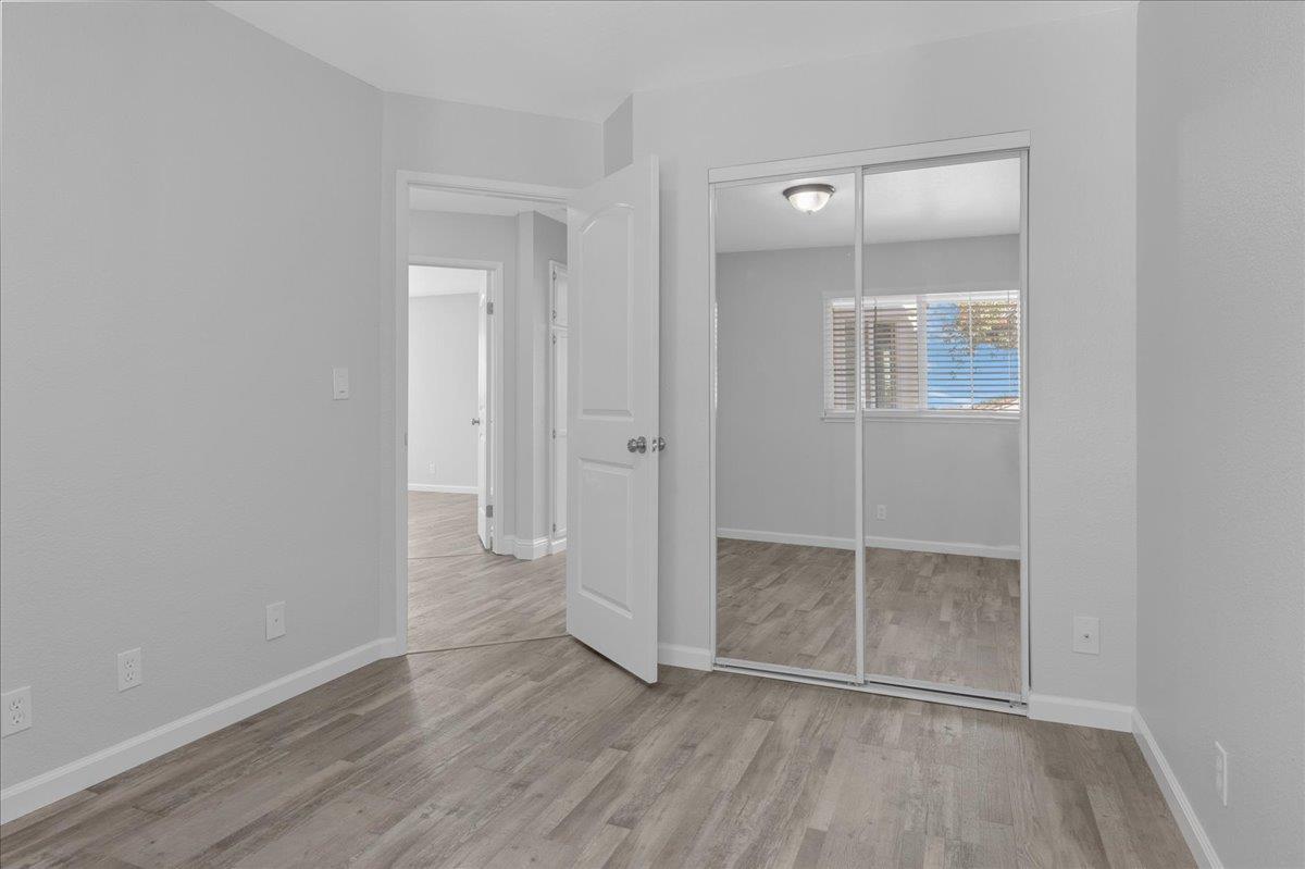 159 Dolphin Circle Marina, CA 93933 - Photo 27 of 31 an empty room with wooden floor and mirror
