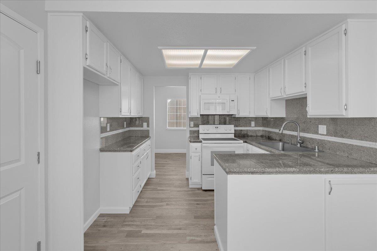 159 Dolphin Circle Marina, CA 93933 - Photo 8 of 31 a kitchen with stainless steel appliances granite countertop a sink stove and refrigerator