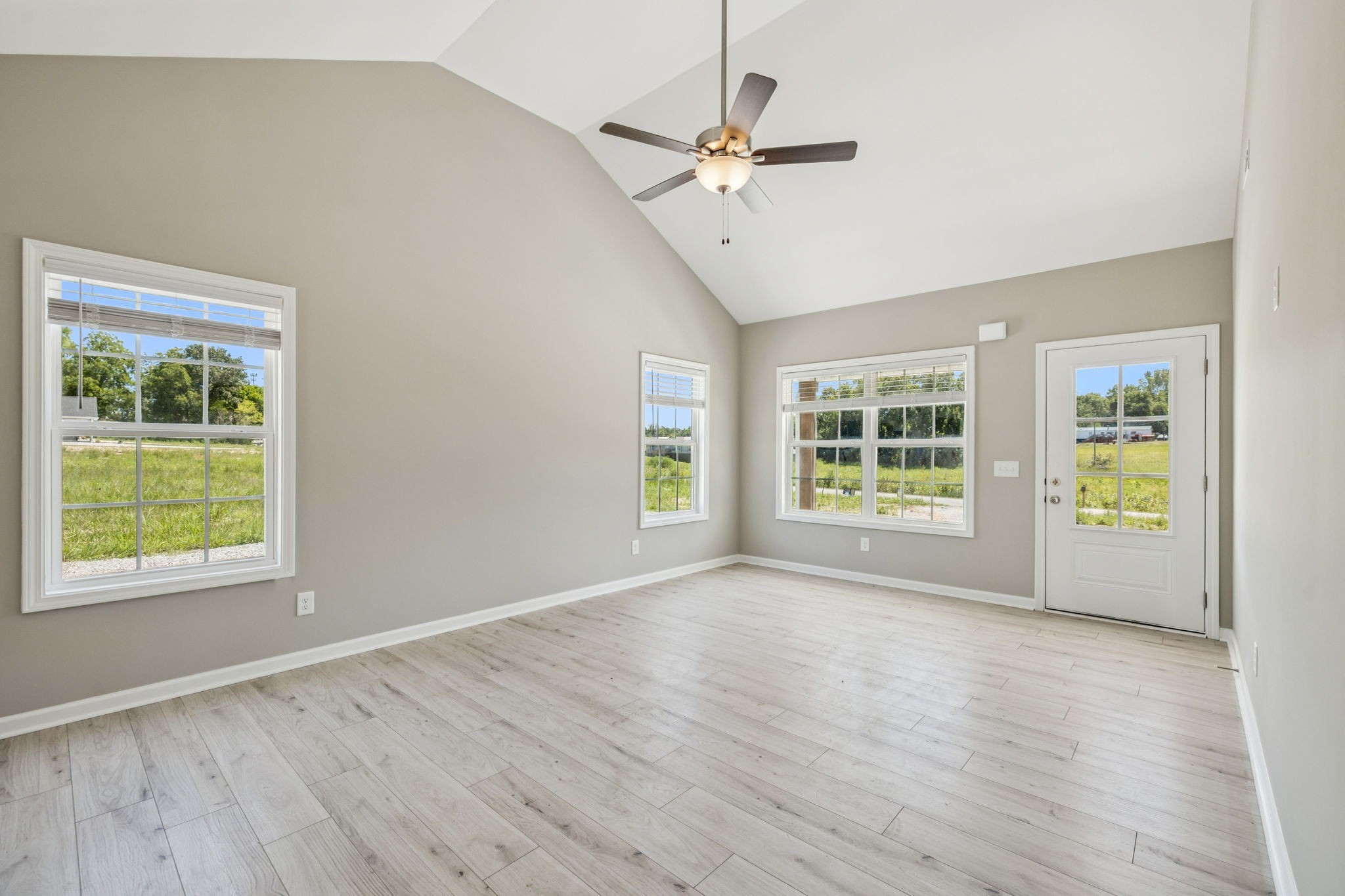 146 Old Brick Church Road Estill Springs, TN 37330 - Photo 11 of 44 a view of an empty room with a window and wooden floor