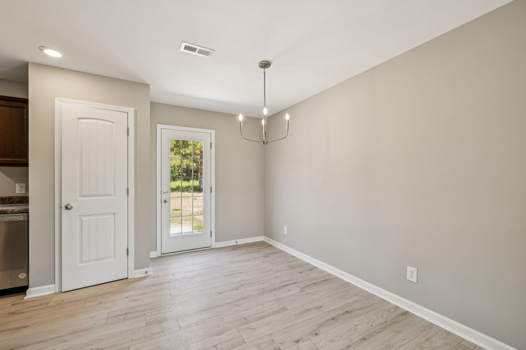 146 Old Brick Church Road Estill Springs, TN 37330 - Photo 12 of 44 an empty room with wooden floor hallway and hallway