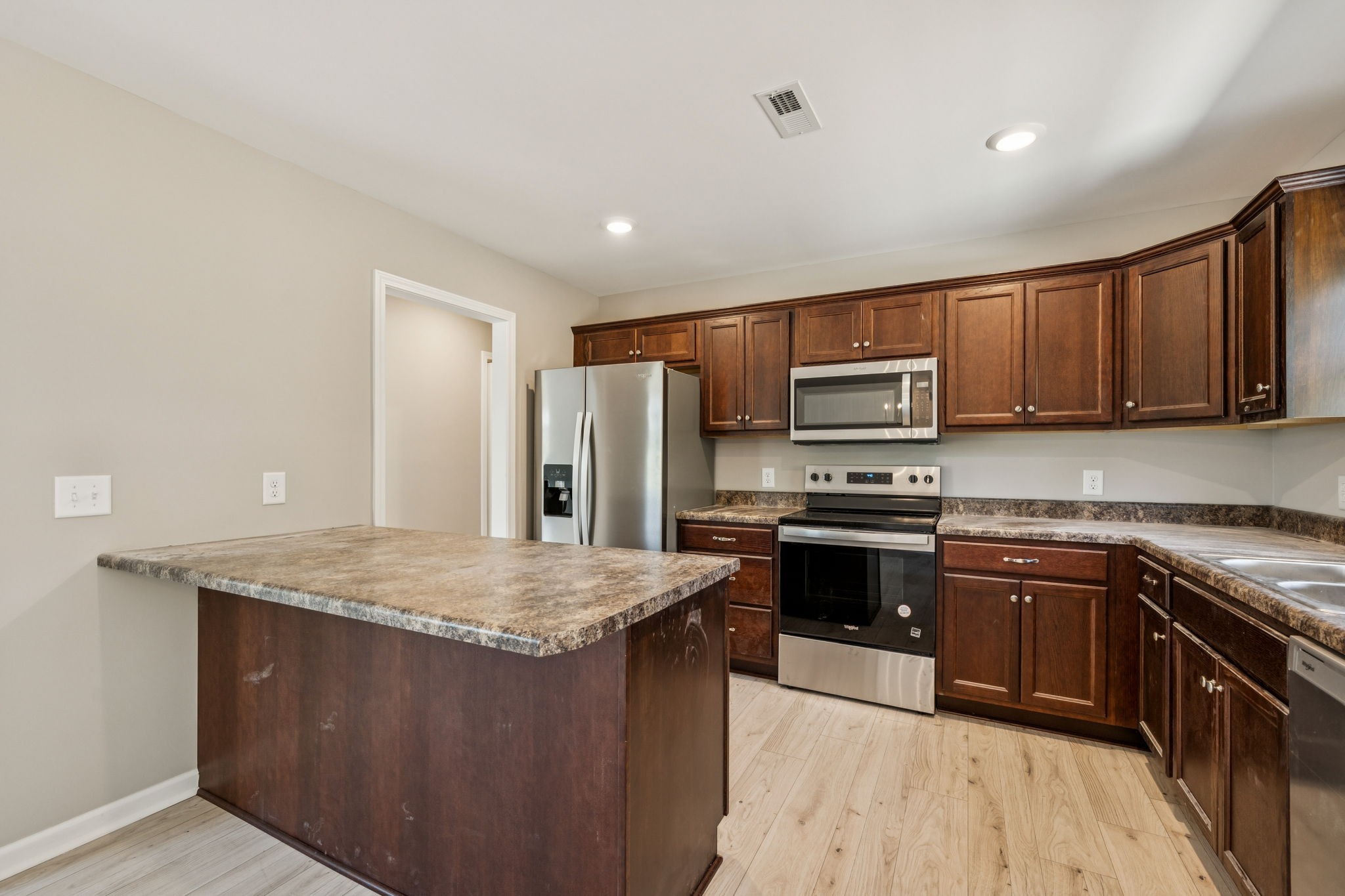 146 Old Brick Church Road Estill Springs, TN 37330 - Photo 16 of 44 a kitchen with stainless steel appliances granite countertop a stove a sink dishwasher a refrigerator and a microwave