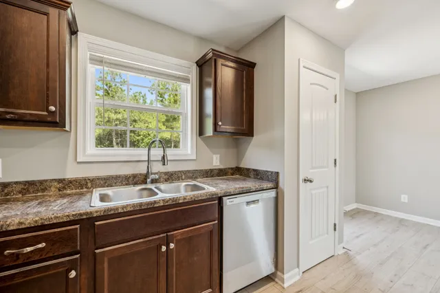 a kitchen with a sink cabinets and window