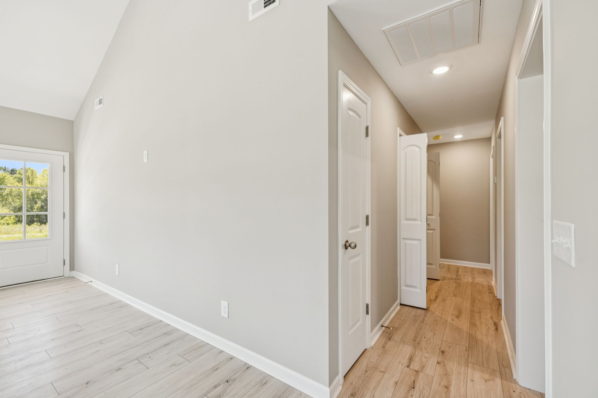 146 Old Brick Church Road Estill Springs, TN 37330 - Photo 23 of 44 a view of a hallway with wooden floor and a bathroom
