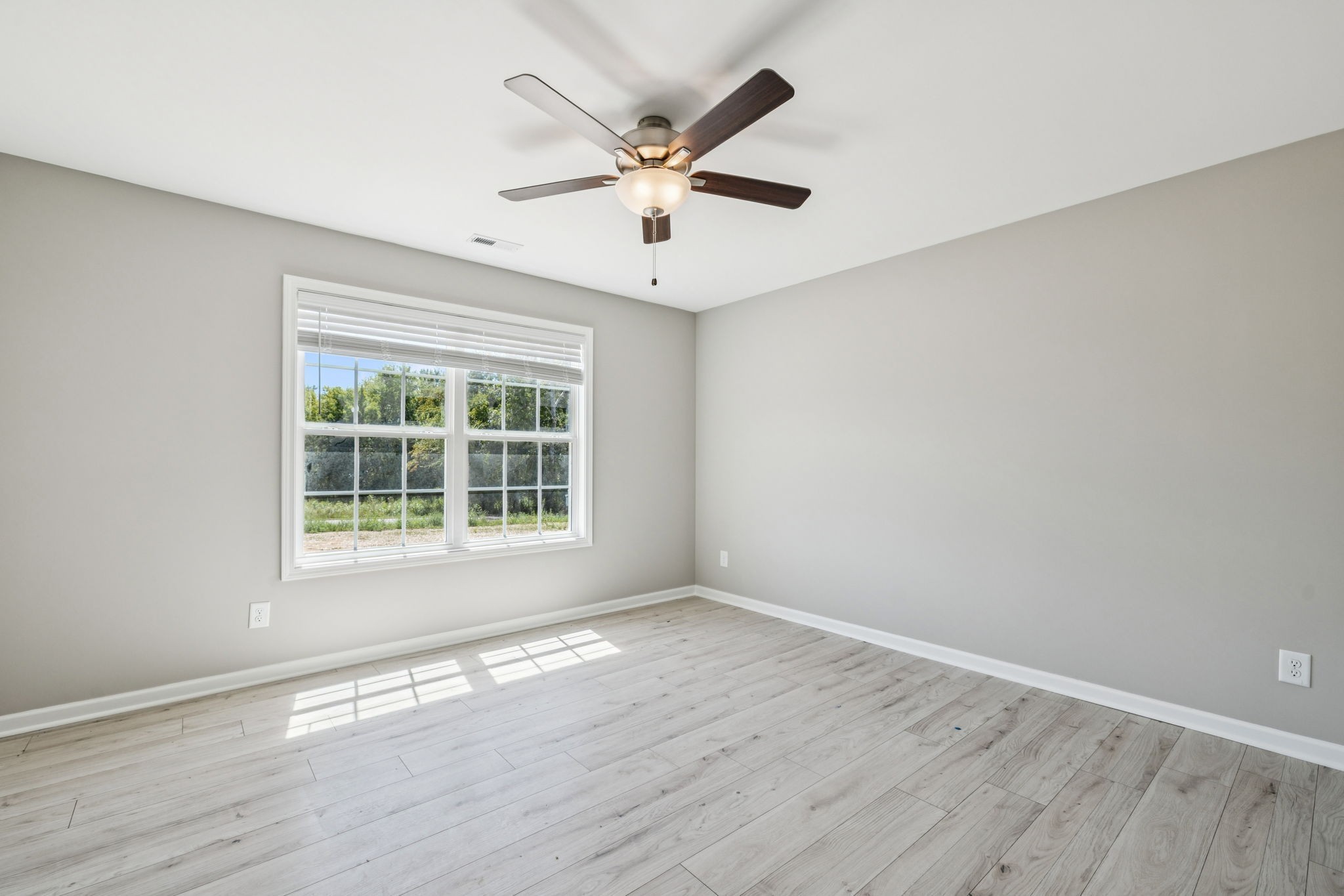 146 Old Brick Church Road Estill Springs, TN 37330 - Photo 32 of 44 a view of an empty room with wooden floor and a window