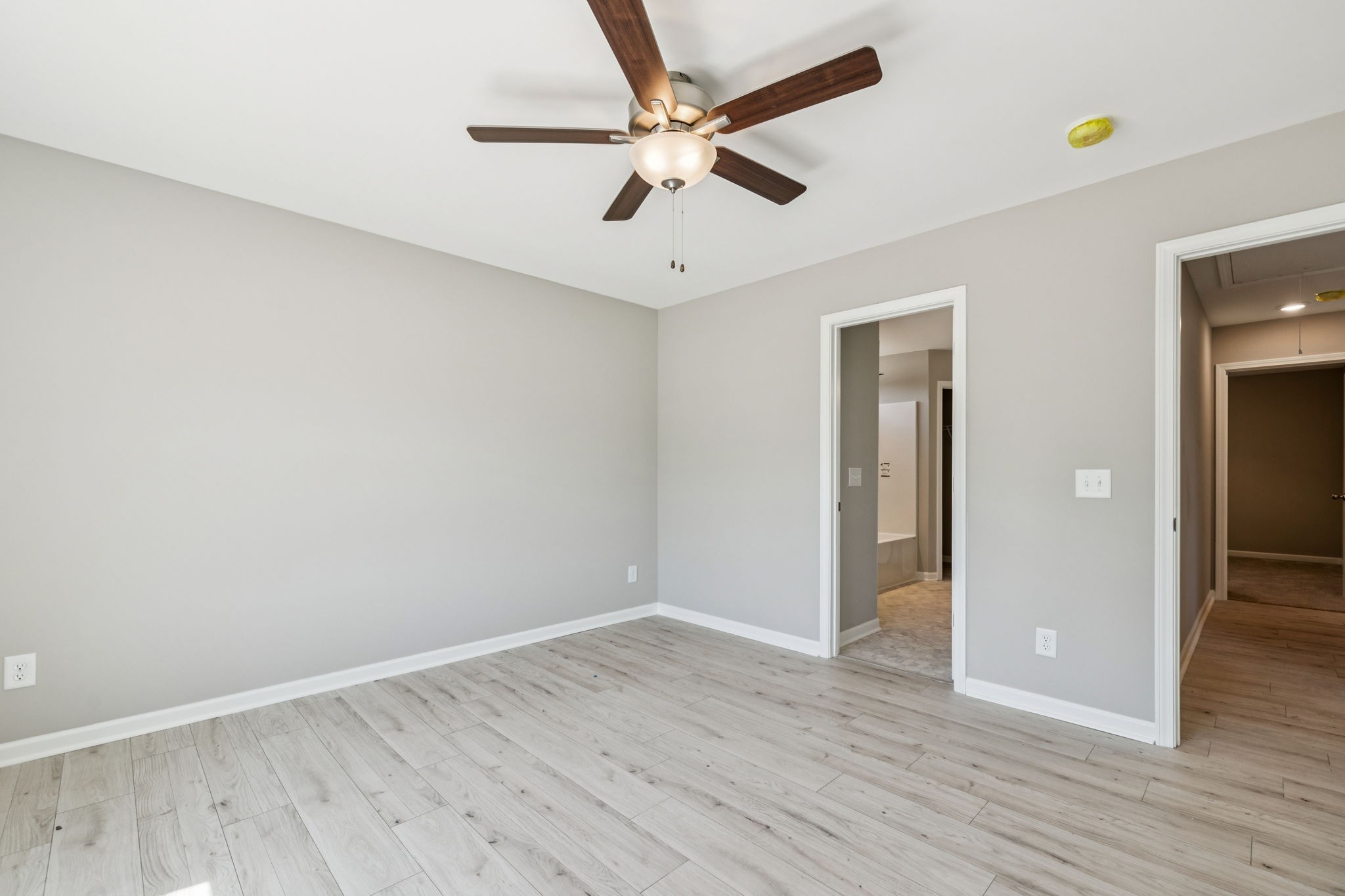 146 Old Brick Church Road Estill Springs, TN 37330 - Photo 33 of 44 an empty room with wooden floor and ceiling fan