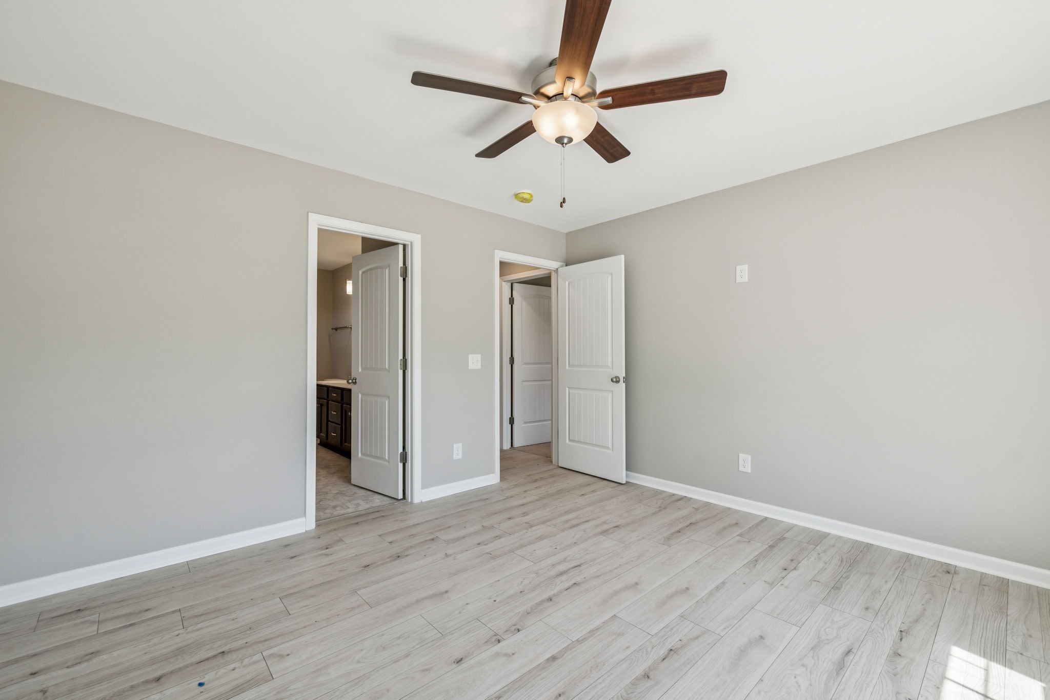 146 Old Brick Church Road Estill Springs, TN 37330 - Photo 34 of 44 an empty room with wooden floor fan and windows