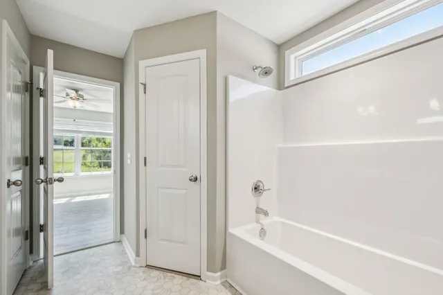 a bathroom with a bathtub and a shower