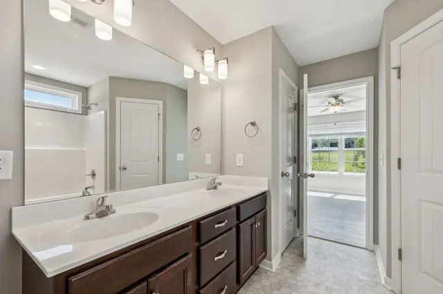 a bathroom with a sink double vanity and a mirror