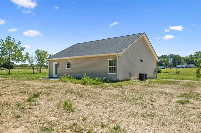 a view of a house with a yard and garage