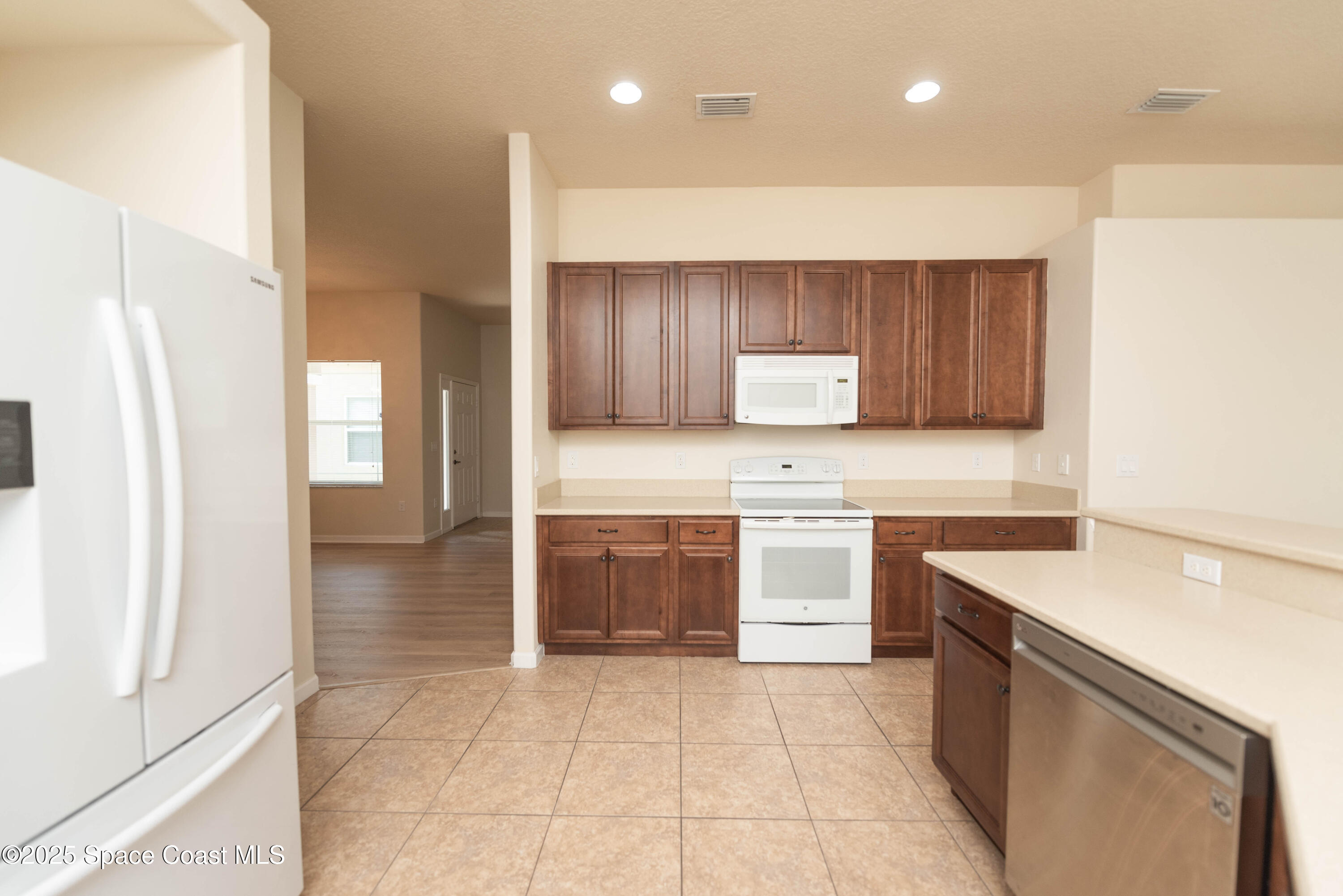 3136 Constellation Drive Melbourne, FL 32940 - Photo 12 of 28 a kitchen with a sink a stove and cabinets