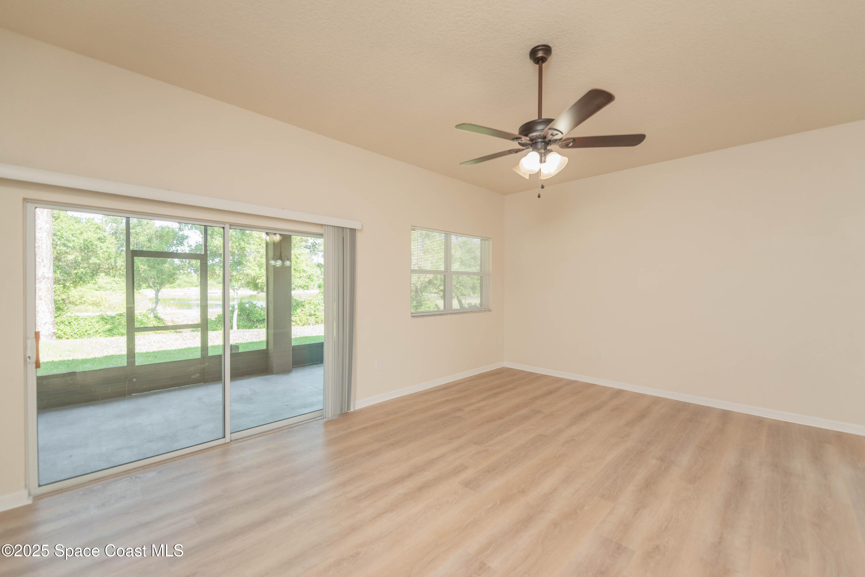 3136 Constellation Drive Melbourne, FL 32940 - Photo 15 of 28 wooden floor in an empty room with a window