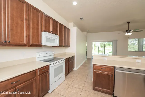 a kitchen with stainless steel appliances granite countertop a sink stove and microwave