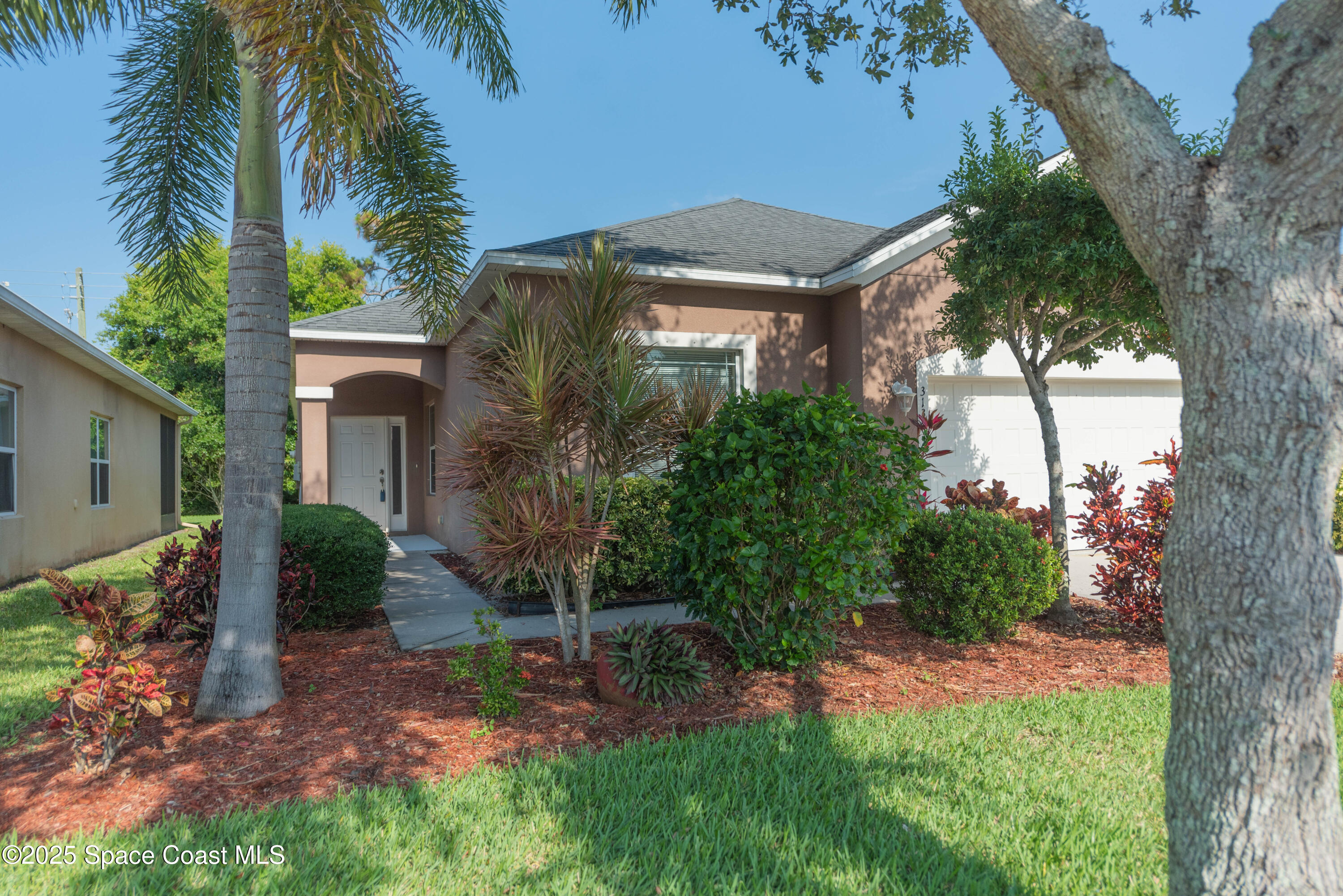 3136 Constellation Drive Melbourne, FL 32940 - Photo 27 of 28 a view of a house with a yard and a tree